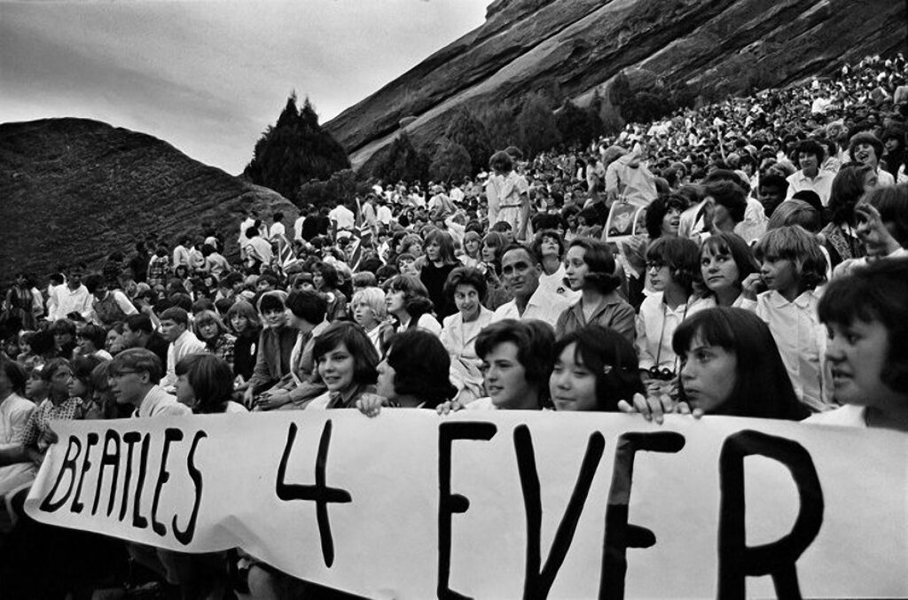 Girls holding "Beatles 4 Ever" sign at Red Rocks concert